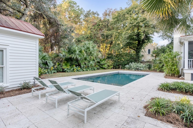 view of swimming pool featuring a patio area