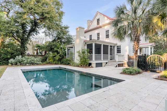 back of property featuring a patio area and a sunroom