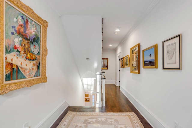 corridor with dark hardwood / wood-style floors and crown molding