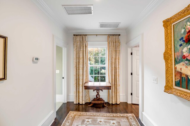 hall with dark hardwood / wood-style flooring and ornamental molding