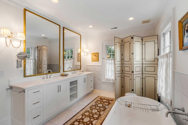 bathroom with tile patterned floors, vanity, and a wealth of natural light