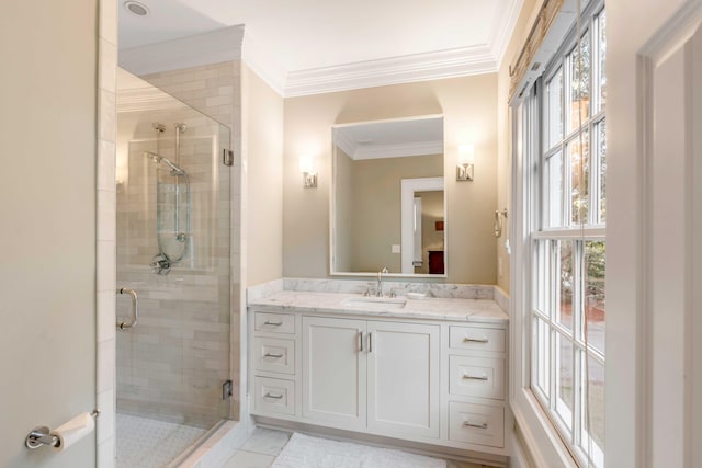 bathroom featuring vanity, a wealth of natural light, and ornamental molding