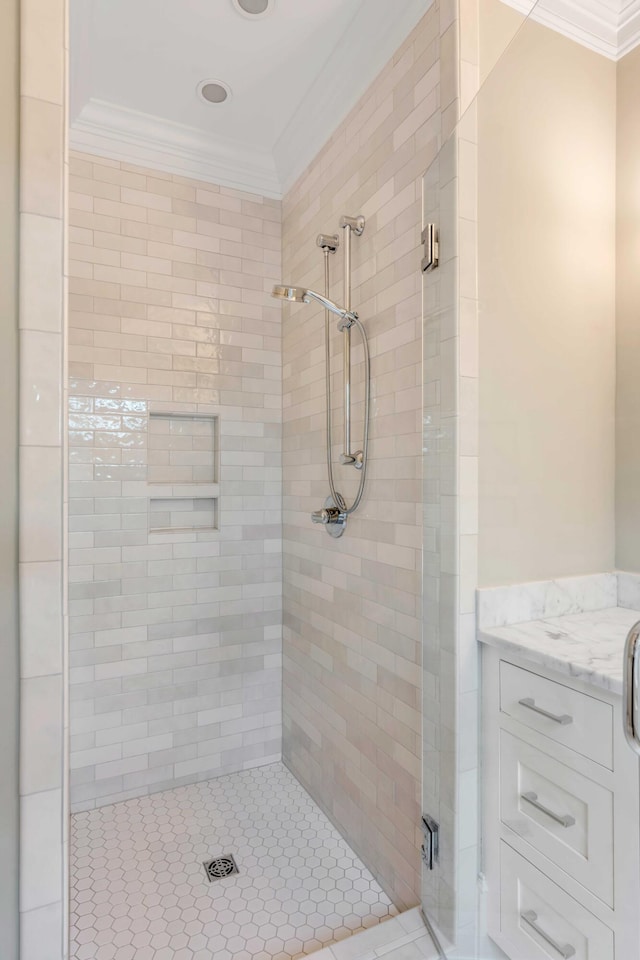 bathroom featuring ornamental molding and a shower with door