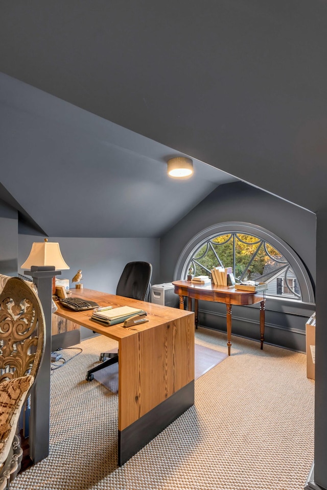 home office with light colored carpet and vaulted ceiling