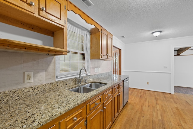 1593 Westwood Dr, Charleston, SC 29412 - kitchen featuring a sink, brown cabinets, light wood-style floors, dishwasher, and light stone countertops
