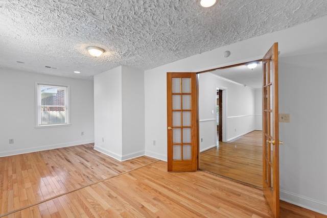 1593 Westwood Dr, Charleston, SC 29412 - empty room with light wood finished floors, baseboards, and a textured ceiling