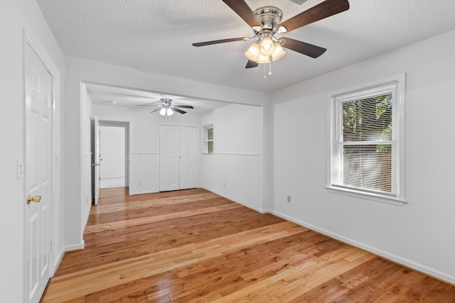 1593 Westwood Dr, Charleston, SC 29412 - unfurnished bedroom with light wood-type flooring, baseboards, a textured ceiling, and a ceiling fan