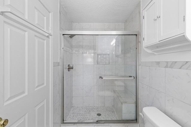 1593 Westwood Dr, Charleston, SC 29412 - full bathroom featuring a textured ceiling, toilet, a stall shower, and tile walls