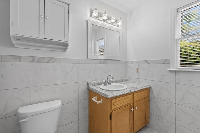 1593 Westwood Dr, Charleston, SC 29412 - half bathroom with tile walls, vanity, toilet, and wainscoting