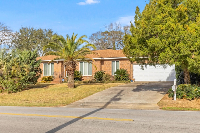 view of front of house with a garage, concrete driveway, brick siding, and a front yard