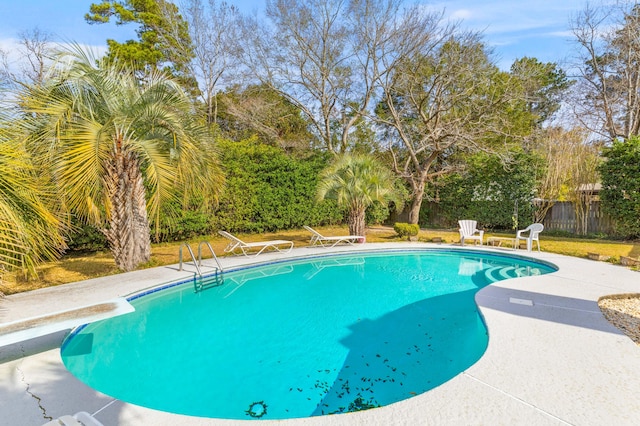 view of swimming pool with a patio area, fence, a diving board, and a fenced in pool