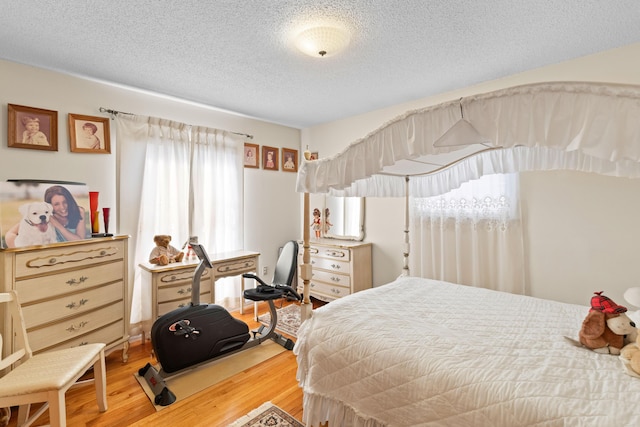 bedroom featuring a textured ceiling and wood finished floors