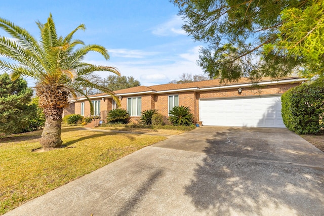 view of front facade featuring driveway, a front lawn, an attached garage, and brick siding