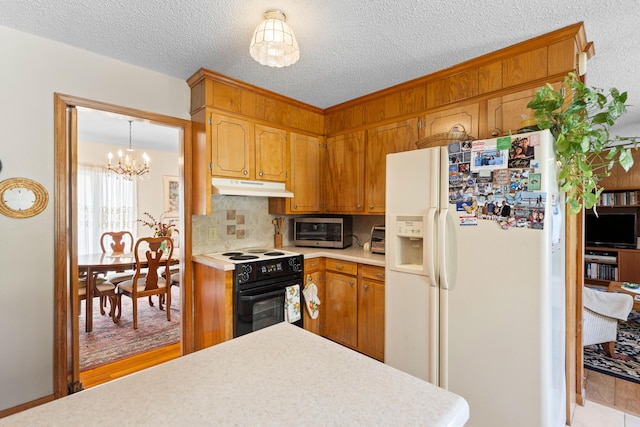 kitchen featuring white refrigerator with ice dispenser, tasteful backsplash, light countertops, range with electric cooktop, and under cabinet range hood