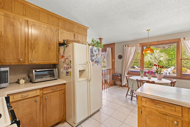 kitchen featuring light tile patterned floors, a toaster, white refrigerator with ice dispenser, stove, and light countertops