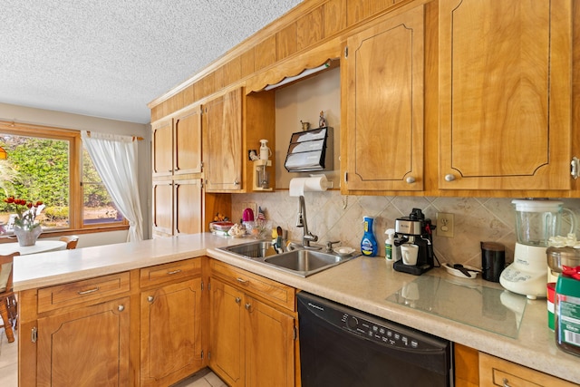 kitchen with black dishwasher, a peninsula, a sink, and light countertops