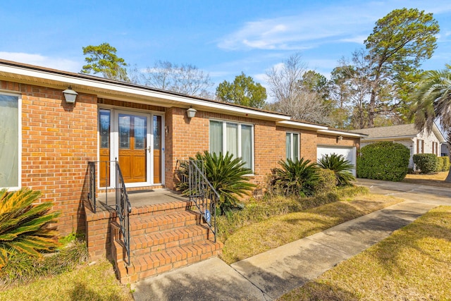 view of front of house featuring a garage and brick siding