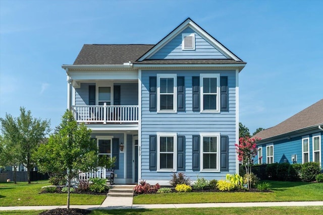 2017 Geranium Ln, Johns Island, SC 29455 - view of front facade with a balcony, a front yard, and covered porch