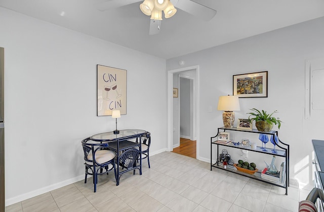 dining area featuring light tile patterned floors, baseboards, and a ceiling fan