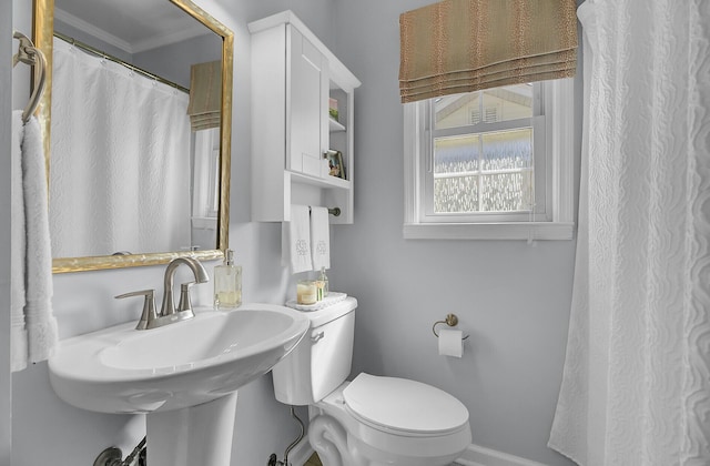 full bathroom with baseboards, a sink, and toilet