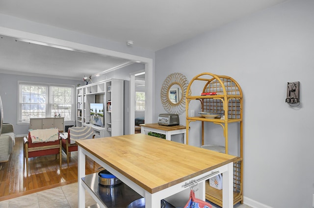 dining space with a healthy amount of sunlight, crown molding, and baseboards