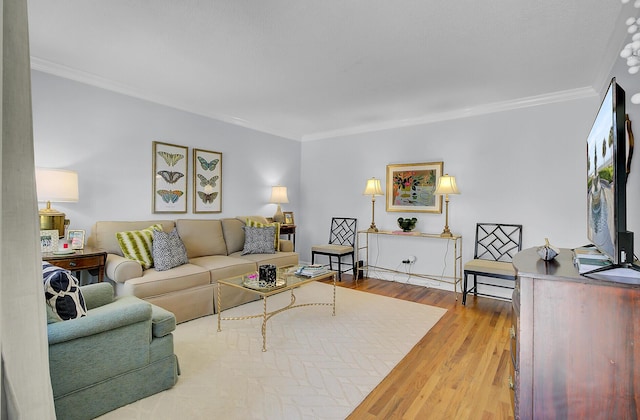 living area with ornamental molding and wood finished floors