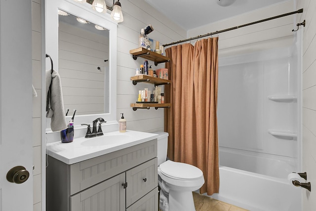 bathroom with toilet, shower / bath combo, wooden walls, and vanity