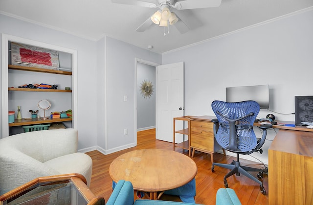 office space featuring ceiling fan, built in features, wood finished floors, and ornamental molding