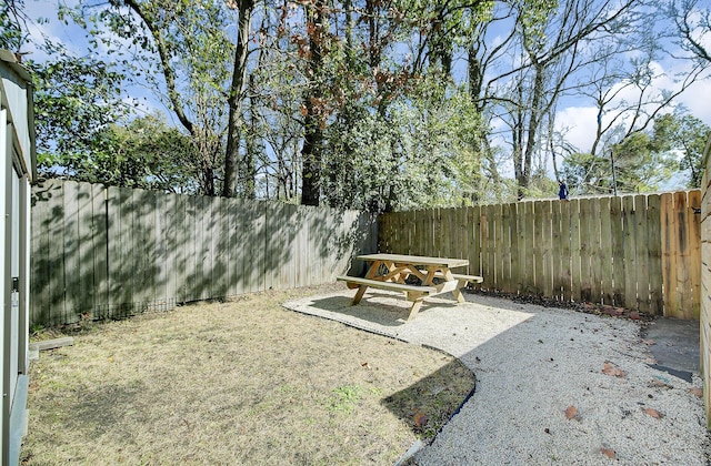 view of yard with a fenced backyard and a patio