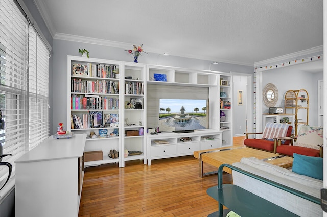 living area featuring hardwood / wood-style floors, a textured ceiling, and crown molding