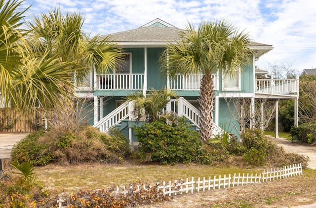 exterior space with driveway, covered porch, and stairs