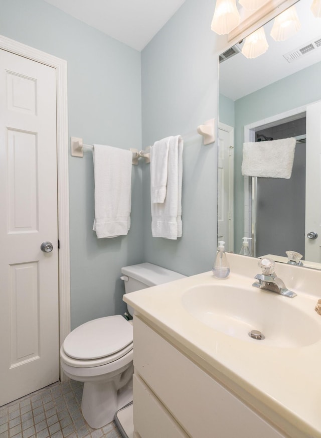 bathroom featuring visible vents, vanity, toilet, and tile patterned floors