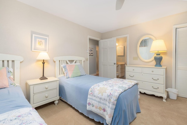 bedroom with ceiling fan, a closet, and light colored carpet