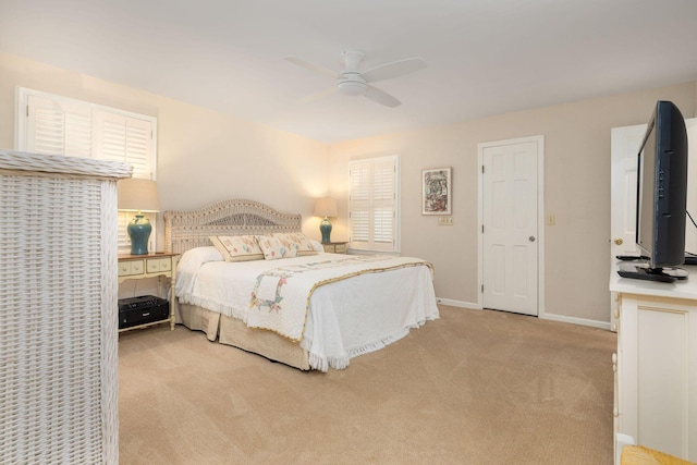 bedroom with light carpet, a ceiling fan, and baseboards