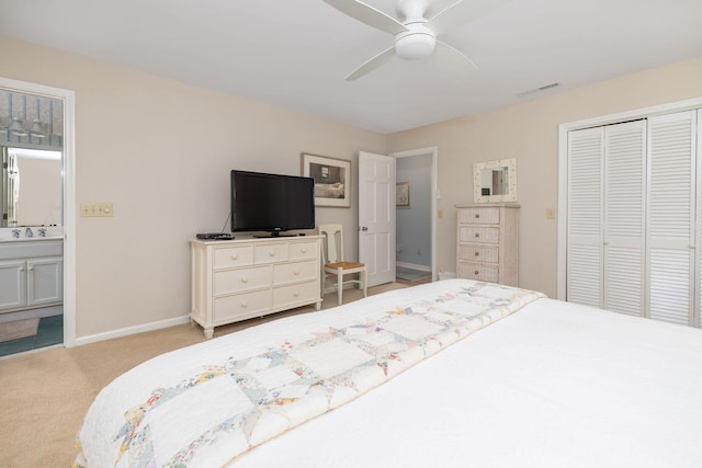 bedroom featuring connected bathroom, carpet flooring, visible vents, baseboards, and a closet