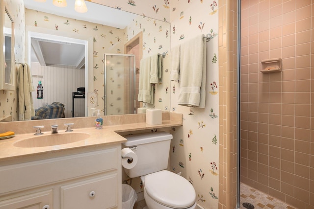 full bathroom with toilet, wallpapered walls, vanity, and a stall shower