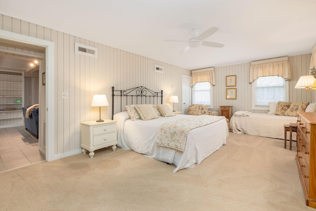 carpeted bedroom with ceiling fan, visible vents, and baseboards