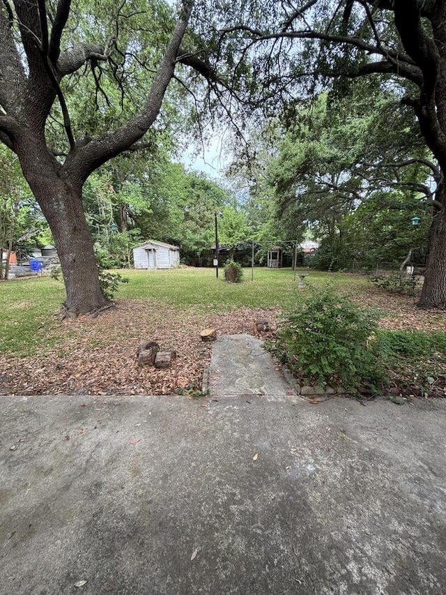 view of green lawn with an outbuilding