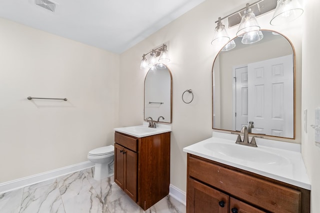 bathroom featuring toilet and vanity