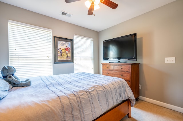 bedroom with light colored carpet and ceiling fan