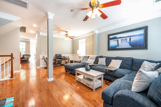 living room featuring crown molding, ceiling fan, and light hardwood / wood-style floors