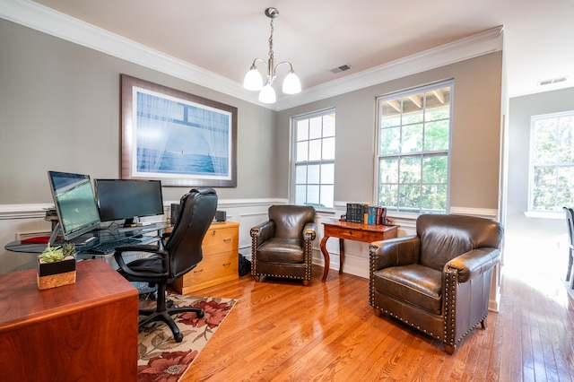 office featuring light wood-type flooring, an inviting chandelier, and ornamental molding