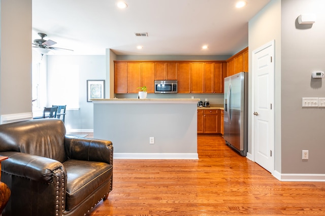 kitchen with ceiling fan, light hardwood / wood-style floors, and appliances with stainless steel finishes