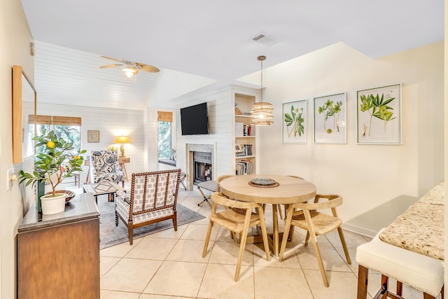 4403 Sea Forest Dr, Kiawah Island, SC 29455 - dining space with ceiling fan, a fireplace, light tile patterned flooring, and baseboards