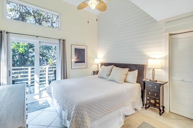 4403 Sea Forest Dr, Kiawah Island, SC 29455 - bedroom featuring multiple windows, a high ceiling, tile patterned floors, a closet, and wood walls