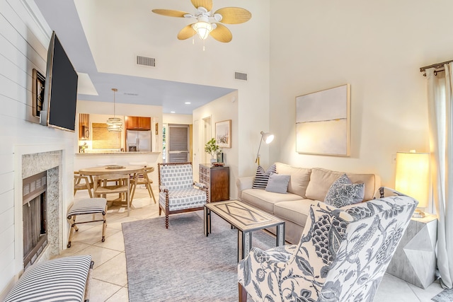 4403 Sea Forest Dr, Kiawah Island, SC 29455 - living room featuring a ceiling fan, a premium fireplace, light tile patterned floors, and a towering ceiling