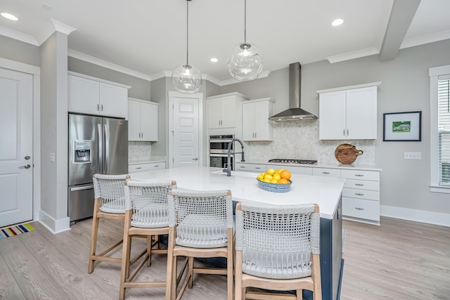 2282 Braided Ln, Mount Pleasant, SC 29466 - kitchen with a kitchen bar, wall chimney range hood, ornamental molding, appliances with stainless steel finishes, and backsplash