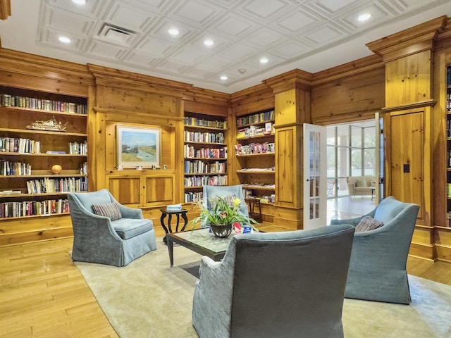 living area featuring an ornate ceiling, recessed lighting, wooden walls, and wood finished floors