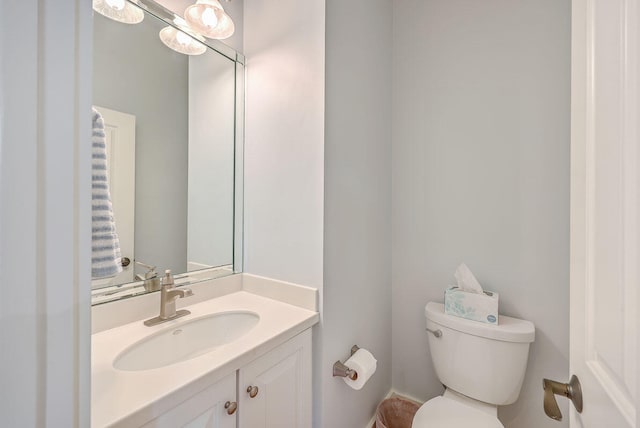 bathroom with large vanity and toilet