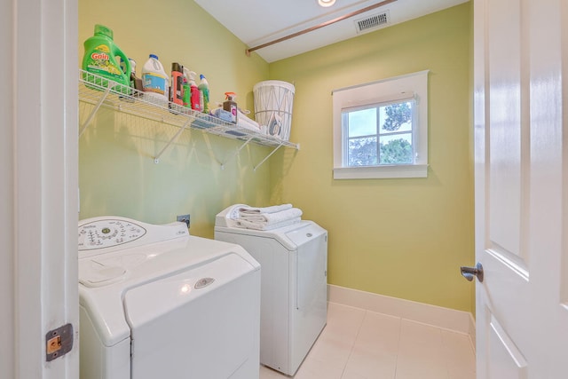 laundry area with tile floors and washer and clothes dryer